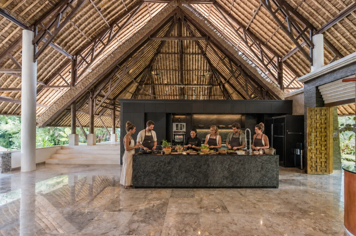 Small group gathered around a dark kitchen island beneath a high open timber roof