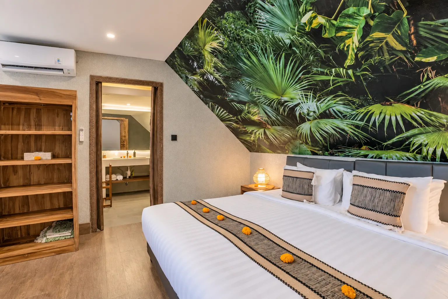 Green Room 2 with botanical wall art, white bed linen, wooden cabinetry and warm bedside lighting