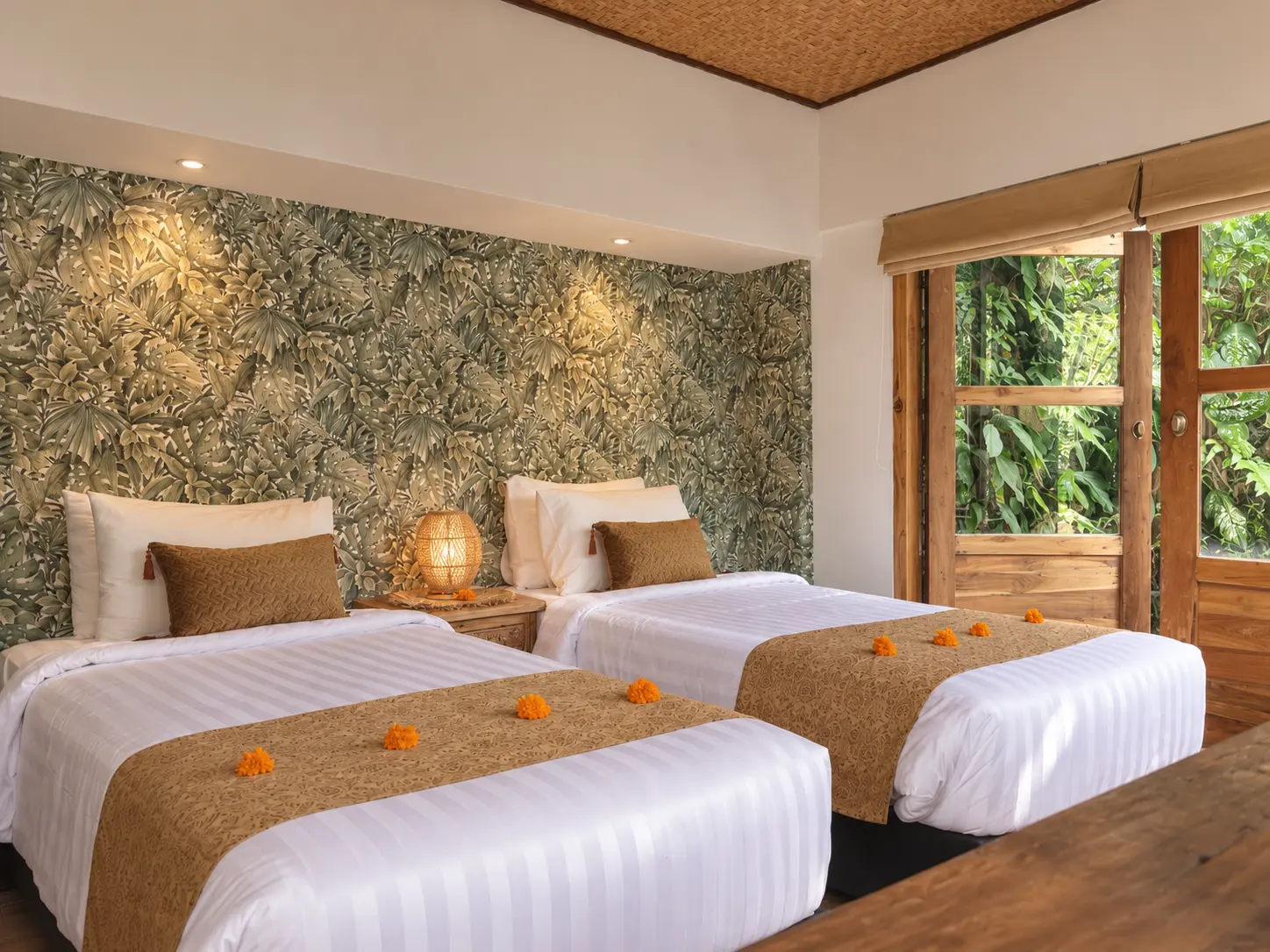 Joglo 1st Floor room with twin beds, botanical wall detailing and large wooden-framed windows