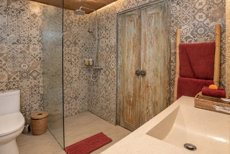 Joglo 1st Floor ensuite with patterned tiles, walk-in rain shower, one toilet and vanity