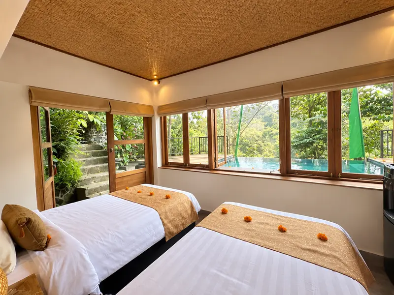 Joglo 1st Floor bedroom from the doorway with twin beds and windows on two sides