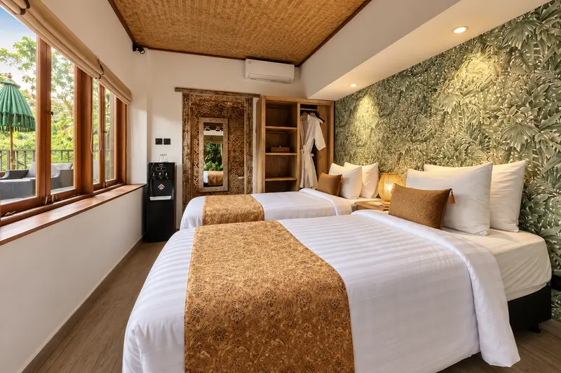 Joglo 1st Floor twin beds beneath a woven ceiling with botanical wall covering and garden windows
