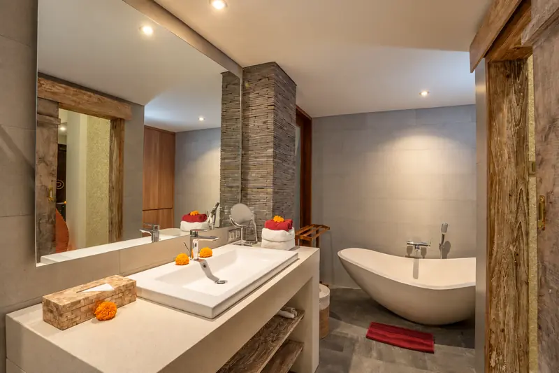 Red Room bathroom with a wide washbasin, large mirror and freestanding bathtub