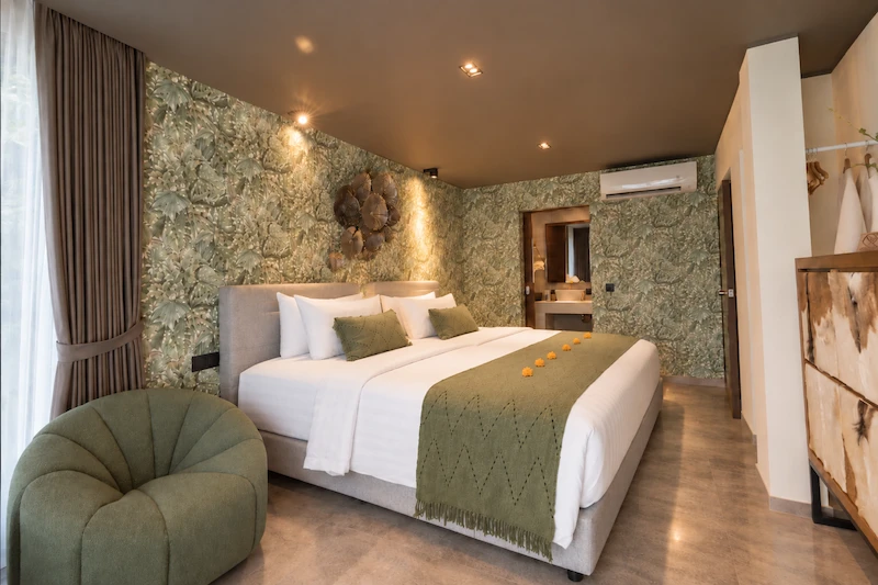 River Villa Room 1 with one large bed and botanical wall covering