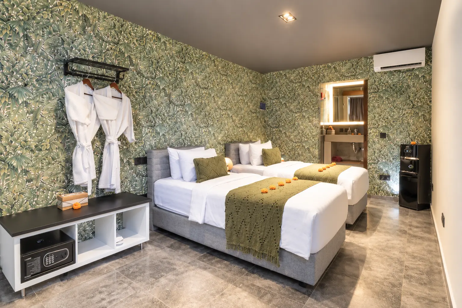 River Villa Room 4 with twin beds, olive-green bed runners and botanical-patterned walls