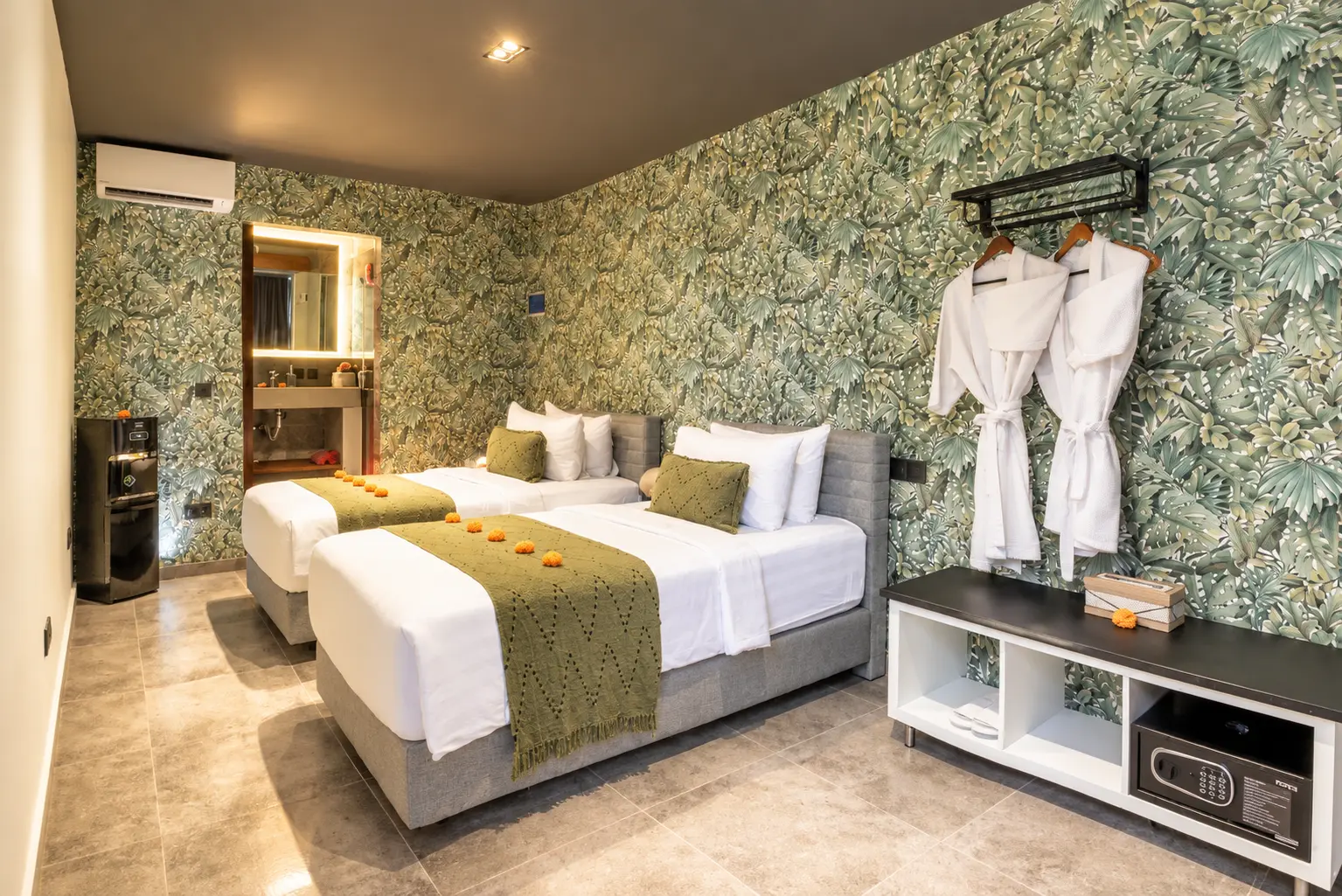 River Villa Room 5 with twin beds, white linen, green bed runners and leafy wallpaper