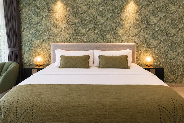 River Villa Room 5 with one large bed and botanical wall covering